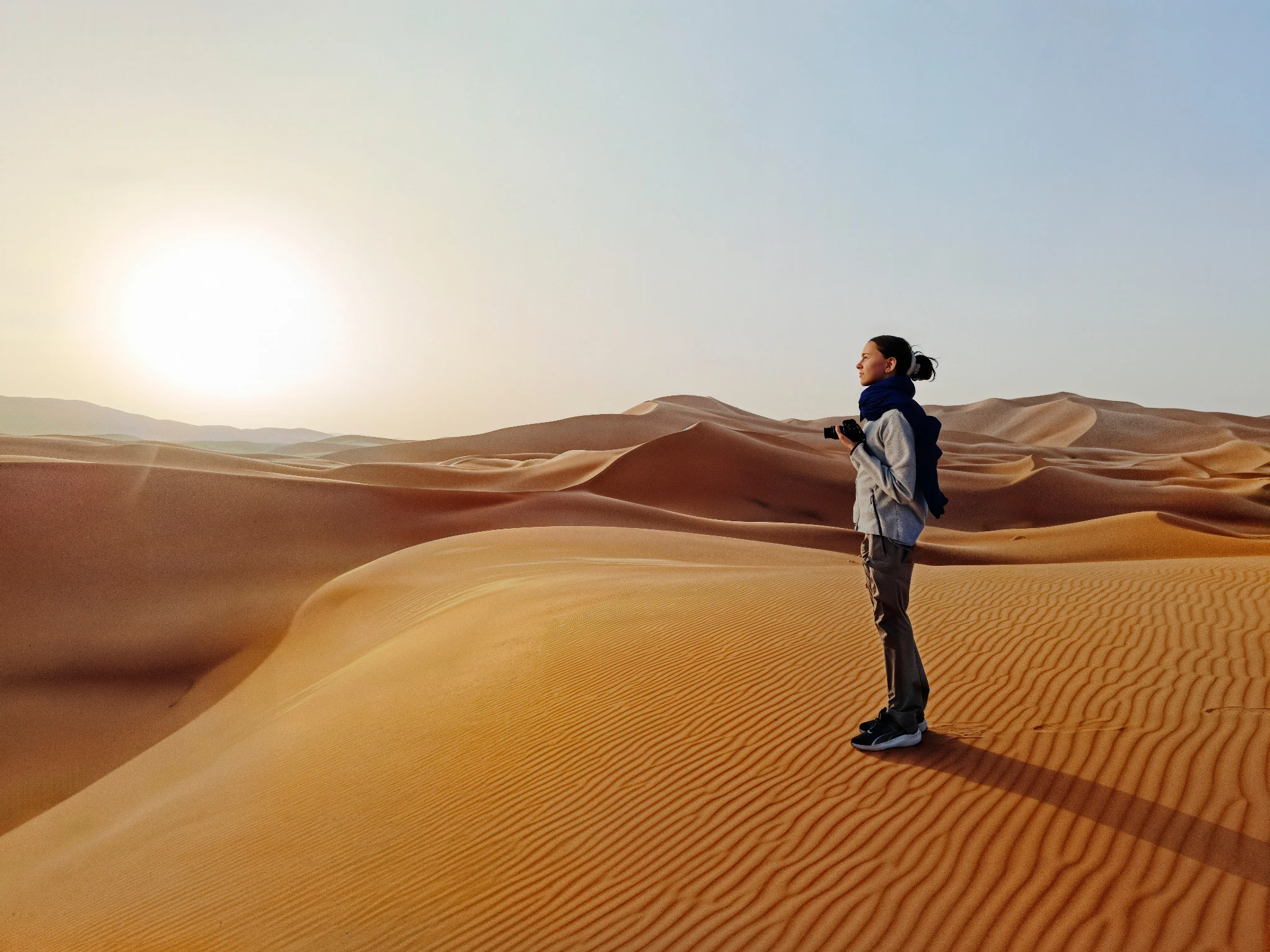 Photographer among desert dunes